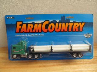 64th Kenworth Cabover semi truck with flatbed trailer and pipe load