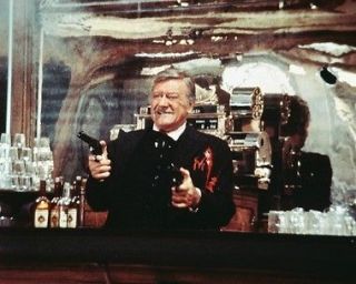 John Wayne classic holding two guns up as he is shot The Shootist 