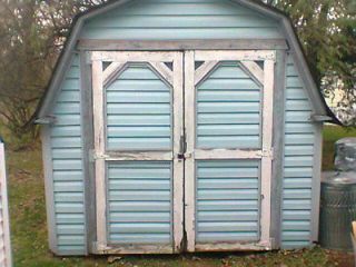 vinyl sided shed with a shingled roof and floor