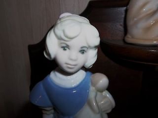 REX VALENCIA porcelain figurine little girl holding doll .hand made in 