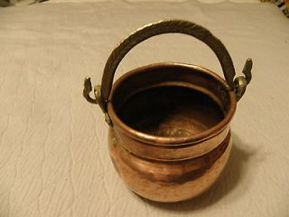 Hammered copper planter with a brass handle