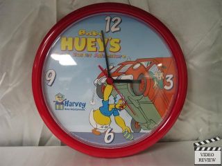 This wall clock features Baby Huey lifting a truck to retreave an 