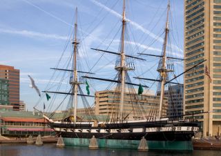 Museum ship USS Constellation against the skyline of Baltimore.
