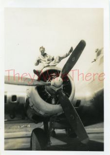     Boeing B 17 Flying Fortress Bomber plane crew member sits on engine