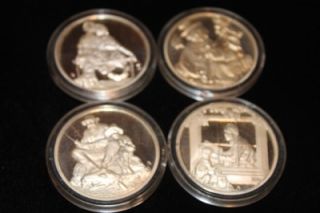 There are 4 one ounce coin. Each coin is in a clear plastic protector
