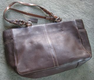 brown leather tote style bag, 2 zippers, 7 pockets, 2 leather handles