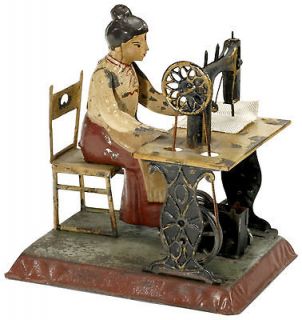 Woman on Sewing Machine, c. 1905 / clockwork tin toy / Günthermann