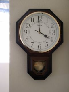 SLIGHTLY USED BATTERY OPERATED WALL CLOCK THAT CHIMES AND DONGS.