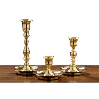 Candlestick Set Of 3 (BrassMaterial Sand casted brass alloy, feltQuantity Three (3) candlesticks Setting Indoors Dimensions Small 2.875 inches high x 3.5 inches diameter, medium 4.625 inches high x 3.5 inches diameter, large 6.75 inches high x 3.5 